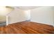Spacious living area featuring wood-look flooring and access to the upper level via stairs at 3623 Landshire View Ln, Raleigh, NC 27616