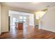 Open-concept living space with sleek wood floors, a kitchen island, and modern stainless steel appliances at 3623 Landshire View Ln, Raleigh, NC 27616