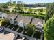 Aerial view showcasing townhome community with modern architecture, landscaping, parking, and convenient access to nearby amenities at 3711 Ramblewood, Durham, NC 27713