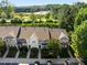 Aerial view showcasing townhome community with modern architecture, landscaping, parking, and convenient access to nearby amenities at 3711 Ramblewood, Durham, NC 27713
