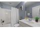 Full bathroom featuring a shower-tub and white vanity with modern fixtures at 3711 Ramblewood, Durham, NC 27713