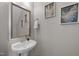 Powder room features a pedestal sink, decorative mirror, and neutral wall paint at 3711 Ramblewood, Durham, NC 27713