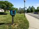 Charming community library box amidst well-manicured lawns, promoting literacy and neighborly connections at 3711 Ramblewood, Durham, NC 27713