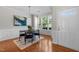 Sunlit dining room with wood floors, charming decor, and a view of the outdoors at 3711 Ramblewood, Durham, NC 27713