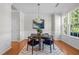 Bright dining room featuring stylish decor, hardwood floors, and a large window at 3711 Ramblewood, Durham, NC 27713