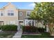 Inviting townhouse boasts a charming exterior with lush landscaping and a colorful flowering shrub at 3711 Ramblewood, Durham, NC 27713