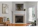 Living room features a decorative fireplace with mantle, neutral wall paint, and hardwood floors at 3711 Ramblewood, Durham, NC 27713