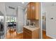 Kitchenette area with wooden cabinets and laminate countertops adjacent to dining room at 3711 Ramblewood, Durham, NC 27713