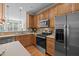 Functional kitchen features stainless steel appliances, wooden cabinets, and modern finishes at 3711 Ramblewood, Durham, NC 27713