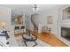 Open floor plan features hardwood floors, modern furnishings, fireplace, and stairway at 3711 Ramblewood, Durham, NC 27713