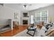 Hardwood floors, modern furnishings, and a fireplace highlight this comfortable living room at 3711 Ramblewood, Durham, NC 27713