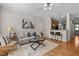 Open floor plan featuring hardwood floors, modern furnishings, and sight lines to the kitchen at 3711 Ramblewood, Durham, NC 27713