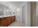 Bright bathroom with double vanity, wood cabinets, a framed mirror, and plenty of natural light at 3936 White Kestreg Dr Dr, Raleigh, NC 27616