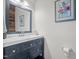 Stylish bathroom vanity with a modern sink, framed mirror, and decorative accents at 3936 White Kestreg Dr Dr, Raleigh, NC 27616