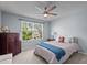 Comfortable bedroom with large window, dresser, and ceiling fan at 3936 White Kestreg Dr Dr, Raleigh, NC 27616