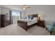 Spacious bedroom with a ceiling fan, a large window with blue curtains, and a wooden dresser at 3936 White Kestreg Dr Dr, Raleigh, NC 27616
