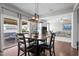 Bright dining room with open floor plan, stylish light fixture, and sliding door access to outdoor living area at 3936 White Kestreg Dr Dr, Raleigh, NC 27616