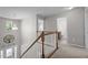 Bright hallway features a chandelier, staircase with wooden handrail, and doorway to the bathroom at 3936 White Kestreg Dr Dr, Raleigh, NC 27616