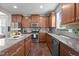 Gourmet kitchen with granite countertops, stainless steel appliances and stylish backsplash at 3936 White Kestreg Dr Dr, Raleigh, NC 27616