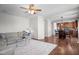 Open-concept living room with hardwood floors, a comfortable sofa, and dining area at 3936 White Kestreg Dr Dr, Raleigh, NC 27616