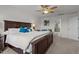 Bright, spacious bedroom with a wooden bed frame, ceiling fan, and a view of the ensuite bathroom at 3936 White Kestreg Dr Dr, Raleigh, NC 27616