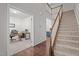 Carpeted staircase with a wooden handrail leads to the second floor near an office at 3936 White Kestreg Dr Dr, Raleigh, NC 27616