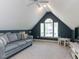 Cozy bonus room with vaulted ceiling, sofa, entertainment center, and natural light providing versatile space at 404 Woodstar Dr, Cary, NC 27513