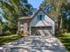 Charming two-story home with siding and brick exterior, manicured lawn, and attached two-car garage at 404 Woodstar Dr, Cary, NC 27513