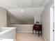 Open hallway featuring a charming writing desk, neutral color palette, and bright lighting creating inviting transition at 404 Woodstar Dr, Cary, NC 27513