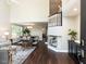 Bright, open-concept living room with dark wood floors, dining area, and a two-story foyer at 404 Woodstar Dr, Cary, NC 27513