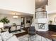 Spacious living room with open dining area, dark wood floors, and two-story foyer at 404 Woodstar Dr, Cary, NC 27513