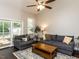 Comfortable living room with vaulted ceilings, dark wood floors, and sliding door access to the backyard at 404 Woodstar Dr, Cary, NC 27513
