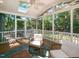 Covered porch with wooden chairs, ceiling fan, and backyard view at 404 Woodstar Dr, Cary, NC 27513
