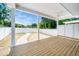Covered back porch overlooking a backyard featuring a privacy fence and sidewalk pavers leading away from the house at 407 Carolina Ave, Raleigh, NC 27606