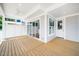 Wide-angle view of back porch showing covered ceiling, privacy wall, sliding glass doors, and an exterior entry door at 407 Carolina Ave, Raleigh, NC 27606