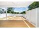 Covered porch with a ceiling fan that overlooks the level, fenced backyard at 407 Carolina Ave, Raleigh, NC 27606