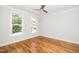 Empty bedroom with hardwood floors, neutral paint, and large windows at 407 Carolina Ave, Raleigh, NC 27606