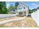 Two-story new construction home with gray siding, a covered back porch, white trim and privacy fence at 407 Carolina Ave, Raleigh, NC 27606