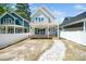 View of home's rear exterior featuring backyard, covered porch, sidewalk pavers, and privacy fence at 407 Carolina Ave, Raleigh, NC 27606