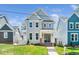 Charming two-story home featuring light gray siding and a well-manicured front lawn at 407 Carolina Ave, Raleigh, NC 27606