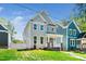Charming two-story home featuring light gray siding and a well-manicured front lawn at 407 Carolina Ave, Raleigh, NC 27606