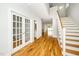 Hallway with hardwood floors and views of the staircase and other rooms at 407 Carolina Ave, Raleigh, NC 27606