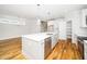 Open concept kitchen with large island, stainless appliances, and an adjoining dining area at 407 Carolina Ave, Raleigh, NC 27606