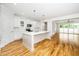 Bright, modern kitchen featuring white cabinets, stainless steel appliances, and a large island at 407 Carolina Ave, Raleigh, NC 27606