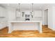 Bright kitchen features a large island with pendant lighting and stainless steel appliances at 407 Carolina Ave, Raleigh, NC 27606