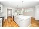 Open kitchen with quartz countertops, stainless appliances, and an adjoining living room at 407 Carolina Ave, Raleigh, NC 27606