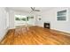 Light-filled living room featuring hardwood floors, a fireplace, and access to the backyard at 407 Carolina Ave, Raleigh, NC 27606