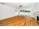 Bright living room with hardwood floors, ceiling fan and sliding glass doors to the backyard at 407 Carolina Ave, Raleigh, NC 27606