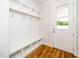 Mudroom with built-in storage, coat hooks, and a door with a window at 407 Carolina Ave, Raleigh, NC 27606