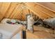 Unfinished attic space featuring exposed wooden beams and insulation wrapped around pipes at 4117 Stansted Dr, Fuquay Varina, NC 27526